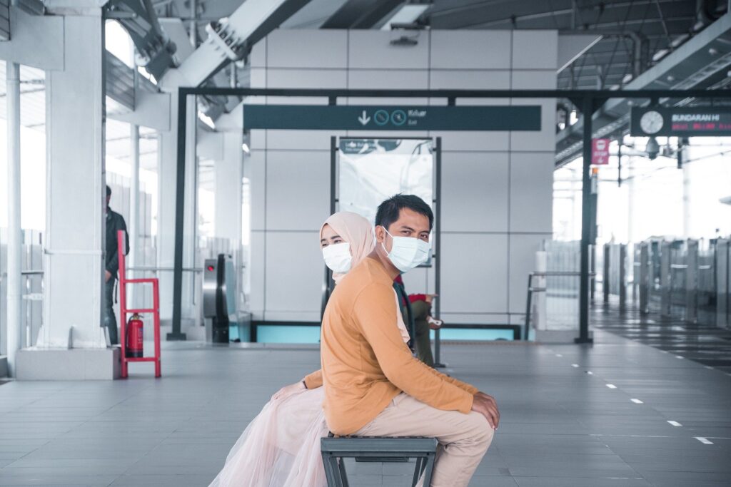 couple in the airport wearing masks